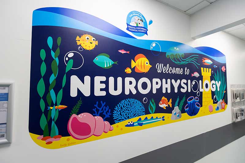 Thumbnail image showing Bright welcome sign at the entrance of the Neurophysiology department printed using Roland DG&#39;s TrueVIS AP-640 Latex Printer
