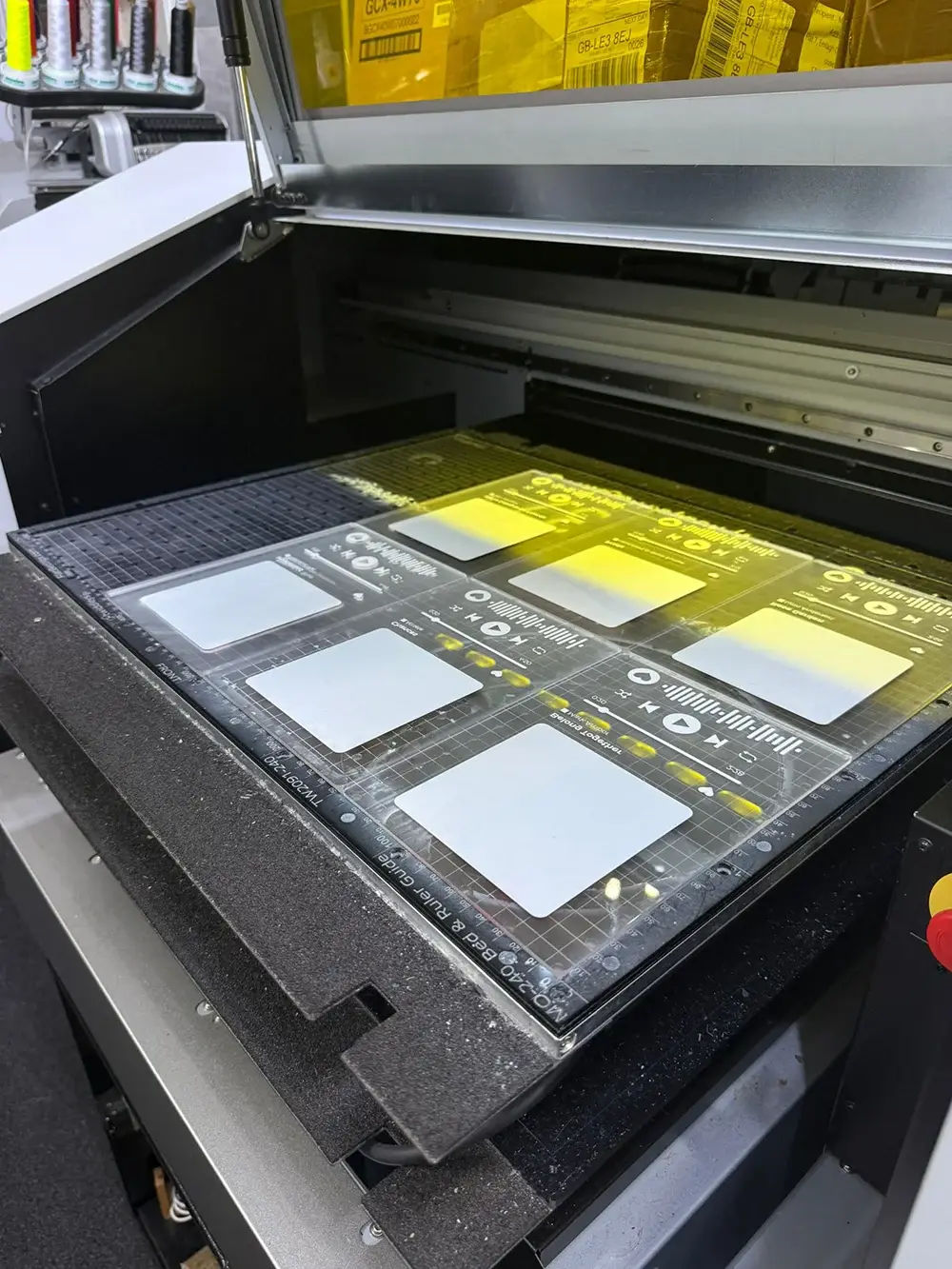 VersaObject MO-240 flatbed printer preparing multiple custom items on the print bed before printing