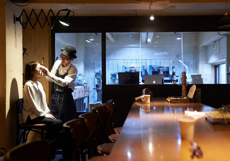Customers at the bar counter can watch bespoke glasses frames being made