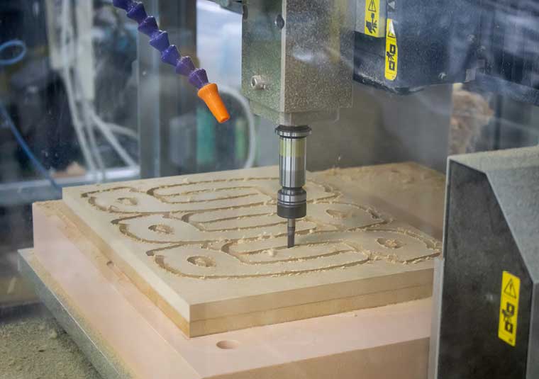 The Roland MDX-540 mills standard MDF to make non-touch door handles