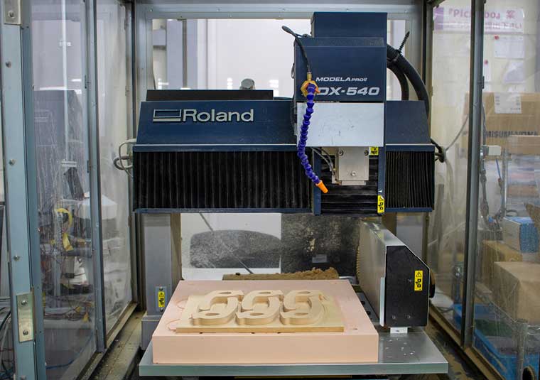 The Roland MDX-540 can produce three sets of hands-free door handles at a time