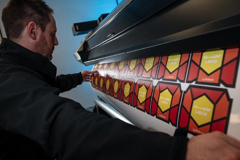 Alex Liggett with UV printed wine bottle labels. 