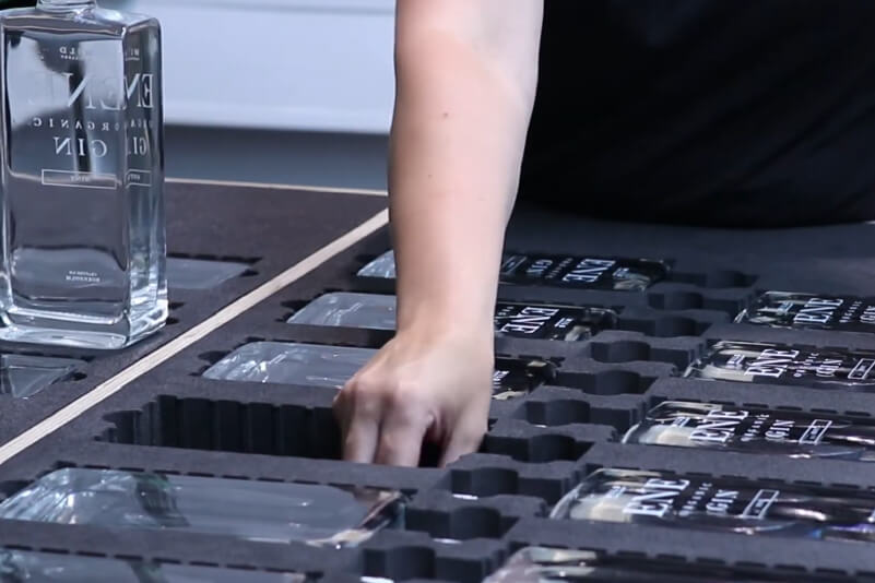 Preparing a run of glass bottles in a UV printing jig (Source: Wild Distillery)