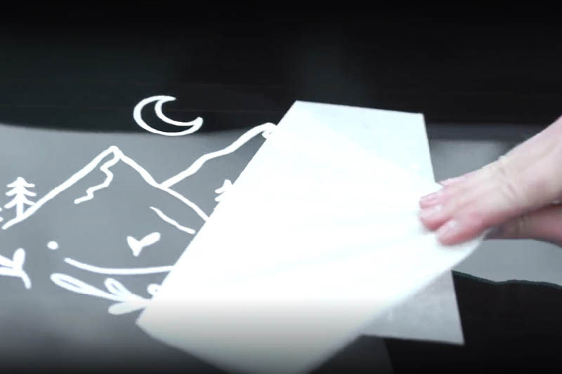 Removing the transfer tape from the vinyl sticker