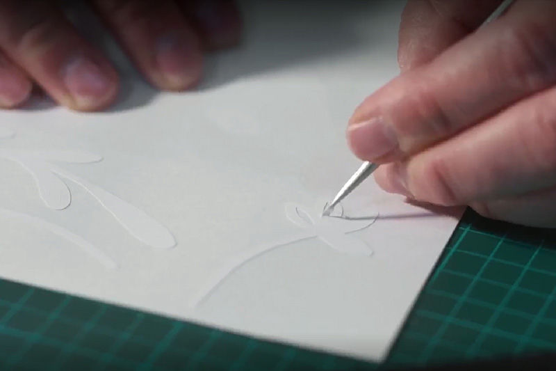 A person weeding white vinyl