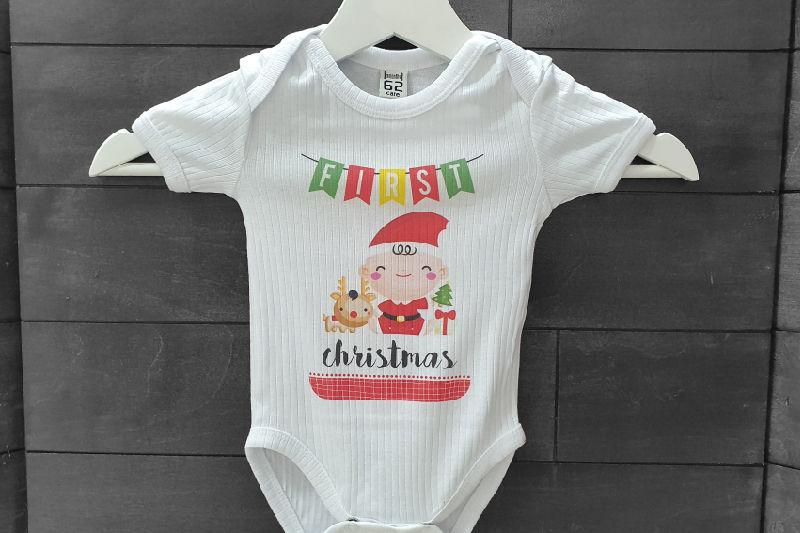 A white babygrow with textured fabric