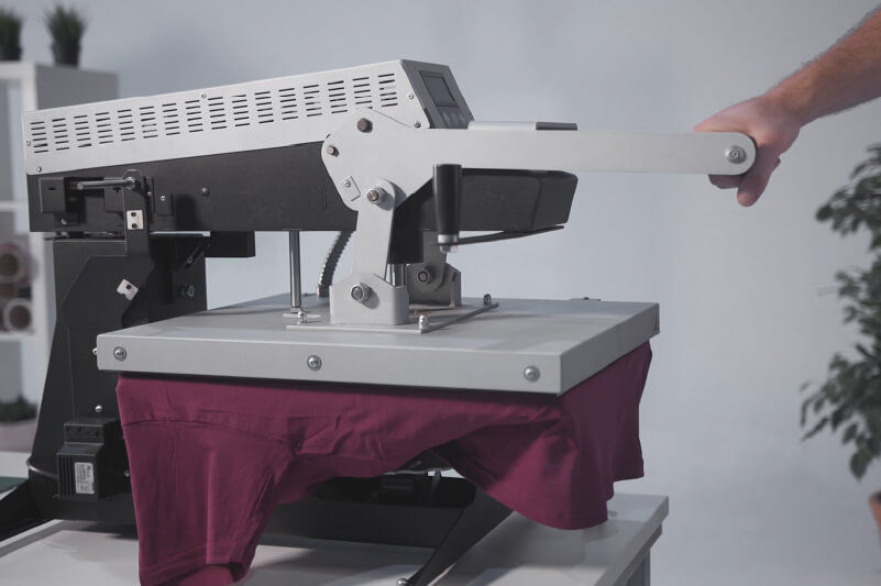 Using a heat press to preheat a T-shirt and remove creases