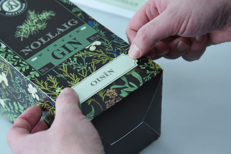 Applying a personalised name sticker to a box