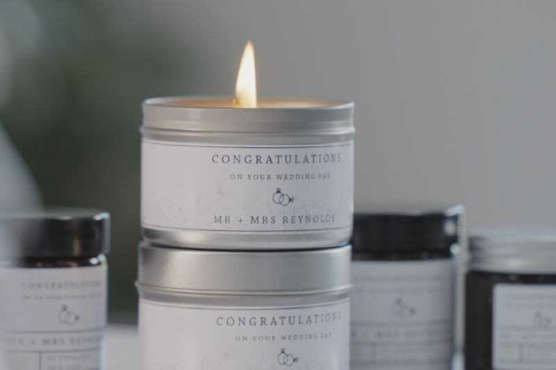 Close up of wedding candle tin with personalised sticker