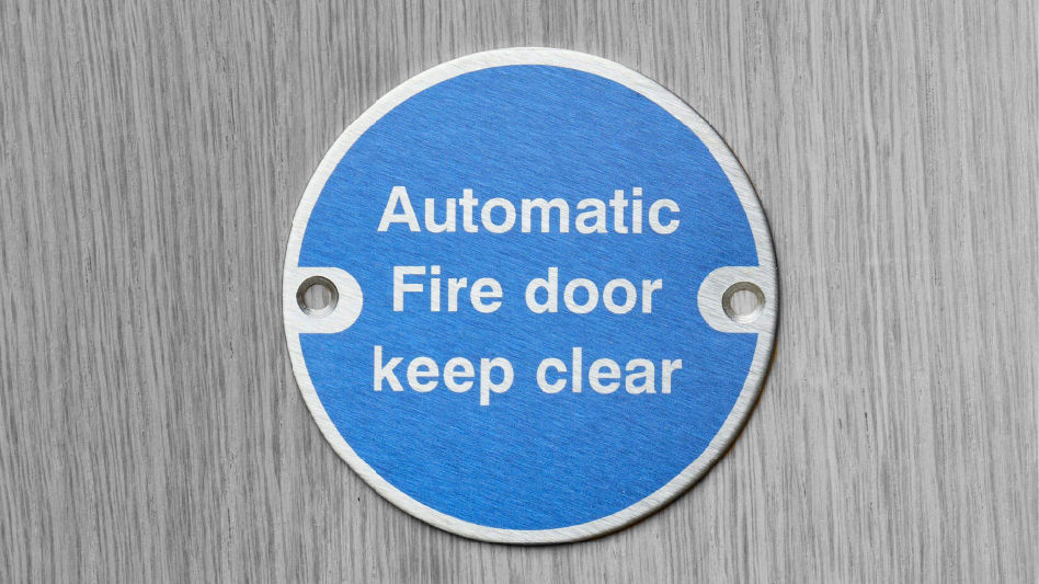 A blue sign with printed on metal