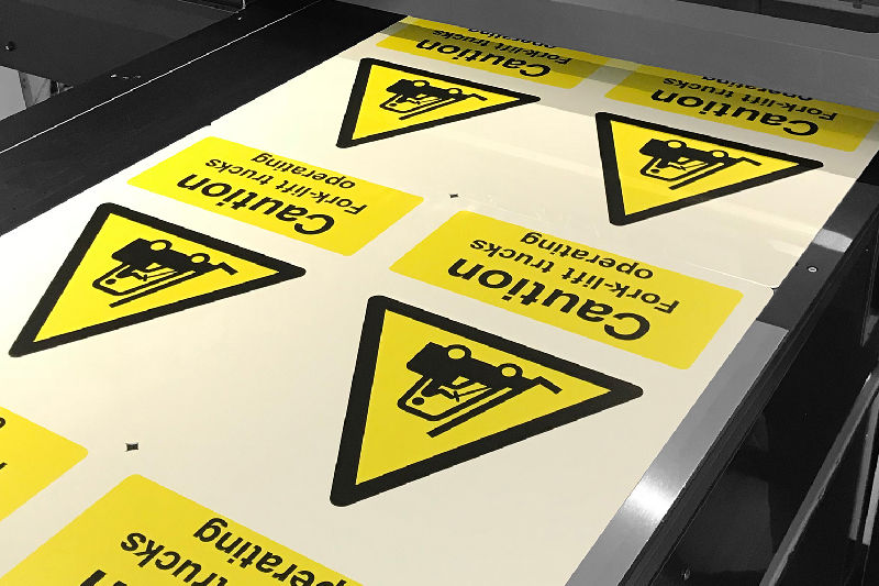 A yellow and black warning signs