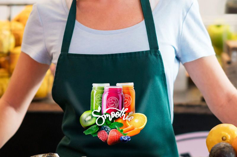 A person wearing a green apron with a printed design