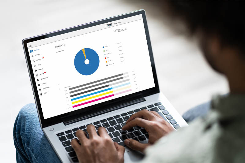 A person using a computer with the Roland DG Connect dashboard