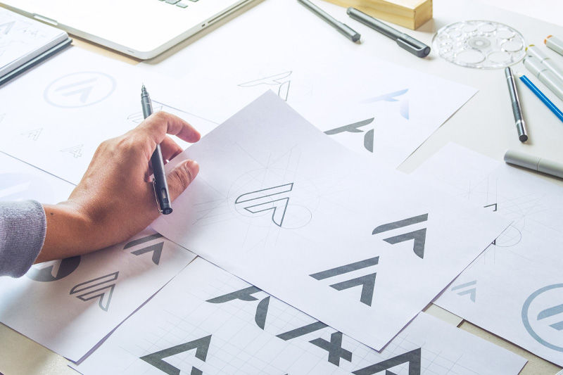 A person working on corporate logo designs
