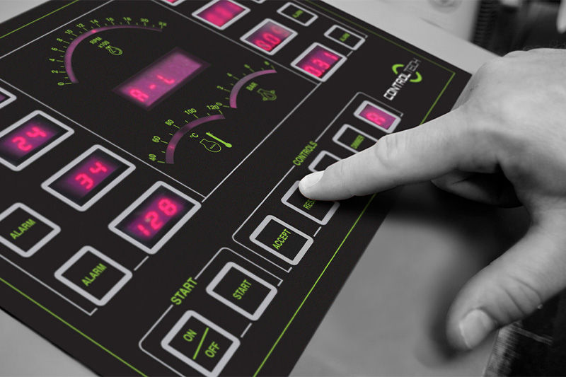 Someone pressing a button on a device on a customised electronics board