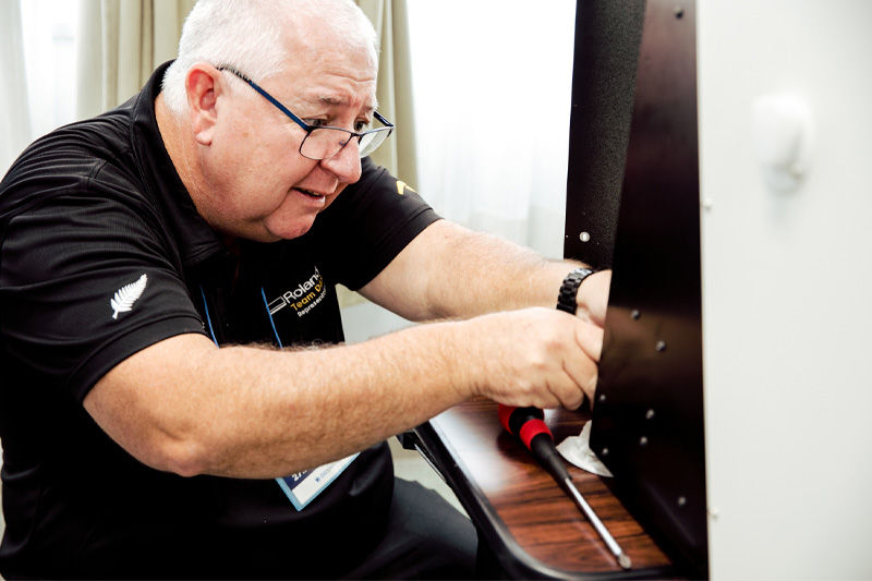 An engineer working on a Roland DG device 
