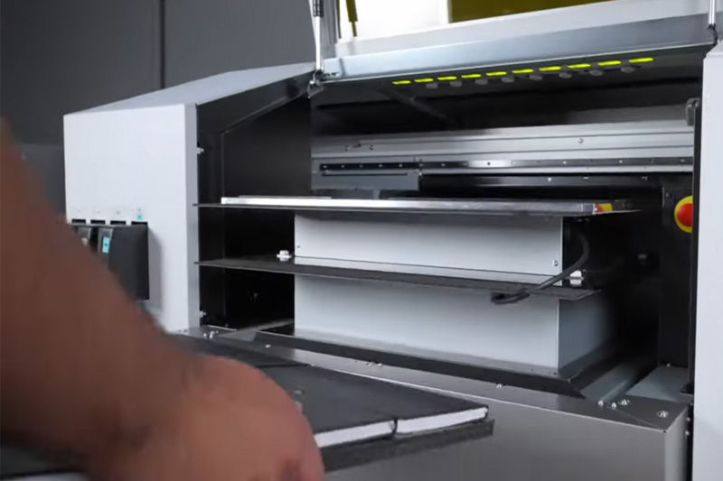 Loading blank notebooks onto the flatbed 