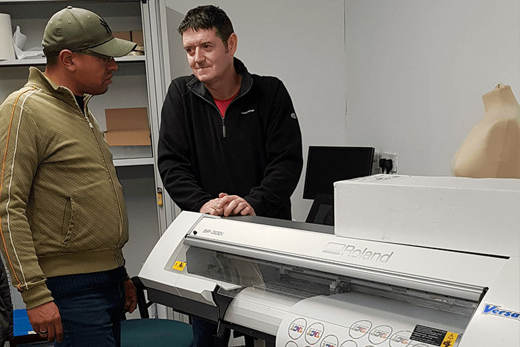 Rob Eyers standing next to his Roland machine