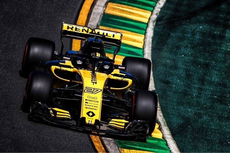 Formula 1 Renault yellow race car on track with sponsor logos printed with a Roland printer added to front