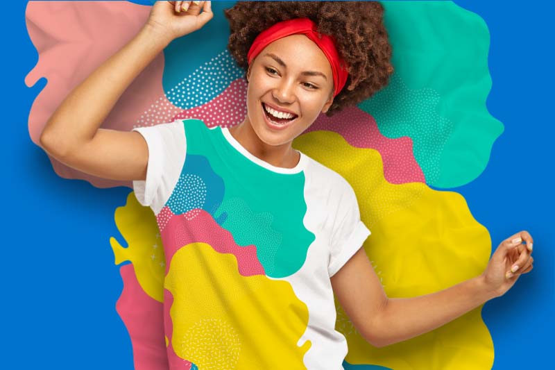 Girl in front of a colorful wall with the same design pattern as on her printed t-shirt